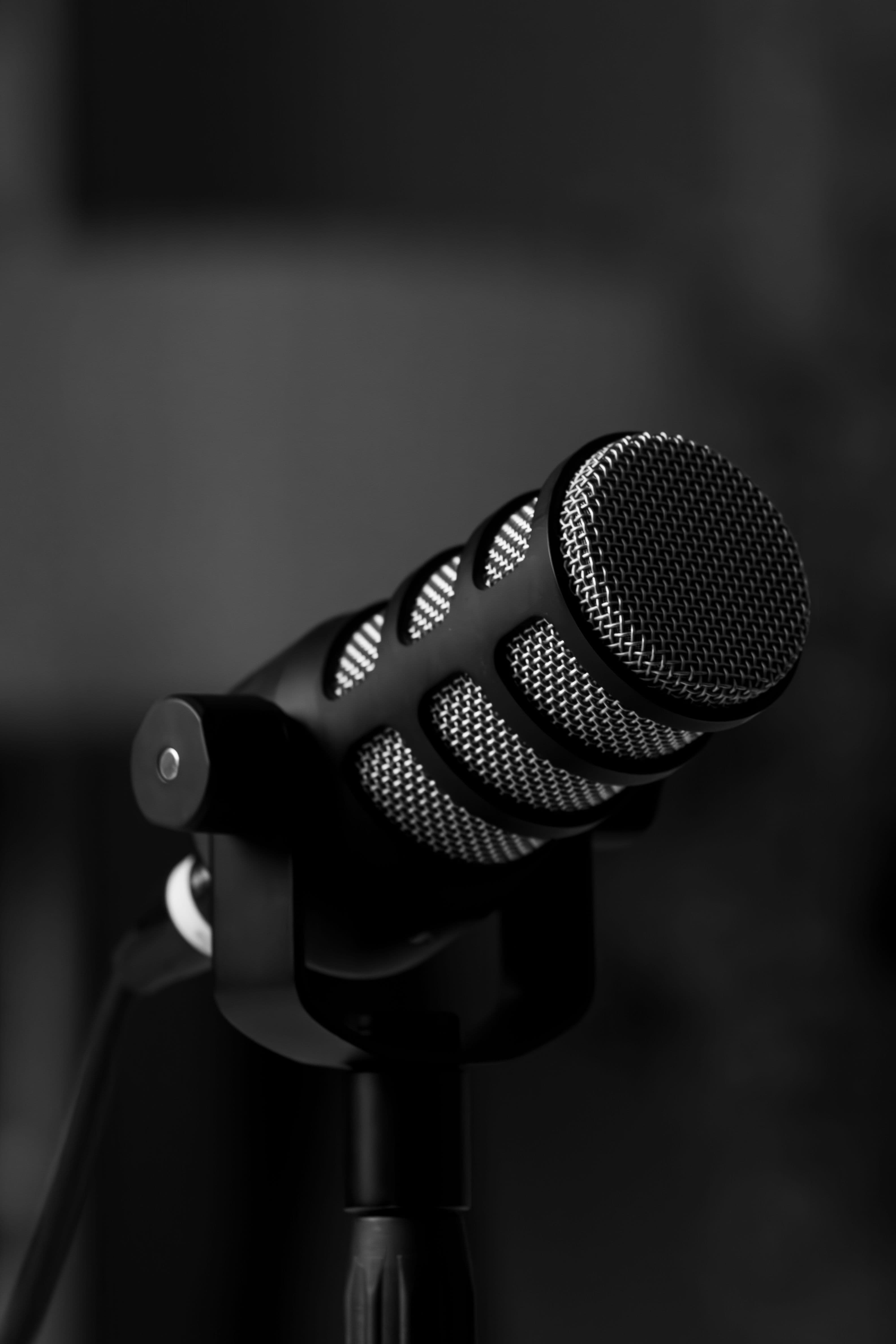 A studio condenser microphone in low light — the Unfiltered Media recording setup