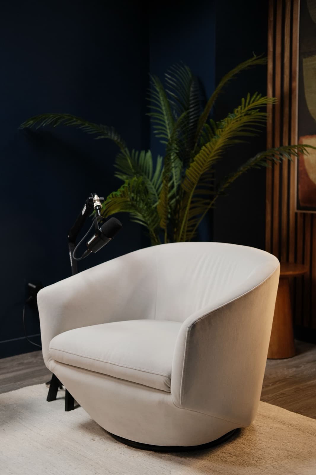 The Unfiltered Media studio — armchair and boom microphone